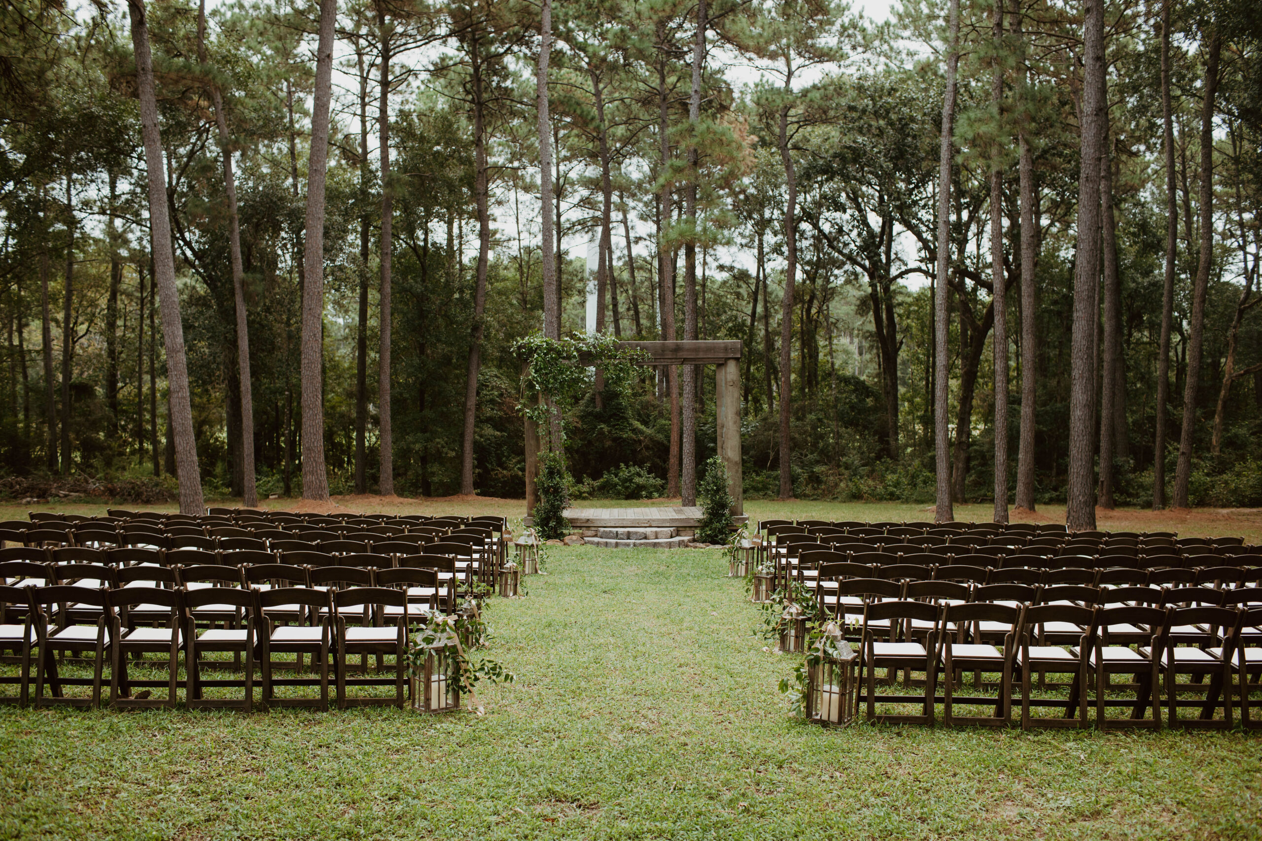 Outdoor-Wedding-Venue Bride pops open champagne with bridesmaids laughing in bridal suite at The Annex wedding venue near College Station